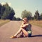 Street Style Fashion Woman Sitting on the Road Outdoors