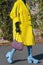 Street style outfit, fashionable woman wears a yellow oversized coat, black and pink print