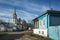 Street of Suzdal, Old wooden traditional russian house half painted blue and Sorrowful Skorbyashchenskaya Church