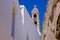 Street in traditional greek village Pyrgos with whitewashed white and blue houses