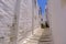 Street in traditional greek village Pyrgos with whitewashed white and blue houses