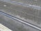 street tram line rails with grey pavement