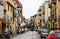 Street with typical Italian apartment buildings and shops in Palermo