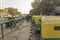 Street urban indian parking green yellow rickshaws near the sidewalk with people