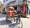 Street vendor carying propane tank on his bike