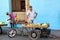 Street vendor selling fruit and vegetables on his bike in the streets of Camaguey, Cuba