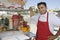 Street Vendor Standing By Stall