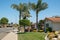 Street view and beautiful houses with nicely landscaped front the yard and clear blue sky background, California