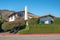 Street view, and beautiful houses with  nicely landscaped front the yard and mountains on background, California