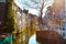 Street view with houses and canal in Delft, Holland at sunset