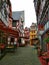 Street view of a narrow alley framed by half-timbered houses in the medieval city center of Limburg an der Lahn, Germany.