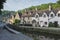 Street view of old riverside cottages in the picturesque Castle Combe Village, Cotswolds, Wiltshire, England - UK