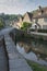 Street view of old riverside cottages in the picturesque Castle Combe Village, Cotswolds, Wiltshire, England - UK