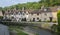 Street view of old riverside cottages in the picturesque Castle Combe Village, Cotswolds, Wiltshire, England - UK