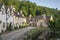 Street view of old riverside cottages in the picturesque Castle Combe Village, Cotswolds, Wiltshire, England - UK