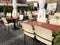 Street view from street tables of a Lviv outdoor cafe with empty tables and chairs