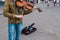 Street violinist plays the violin at noon