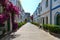 Street with white houses and colorful flowers, small fishing village. Romantic architecture of the port of Mogan in Gran Canaria,