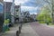 Street in the Zaan region of a village , with traditional wooden green houses .