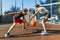 Streetball basketball game with two players, teenagers girl and boy with ball, outdoor city basketball court