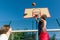 Streetball basketball game with two players, teenagers girl and boy, morning on basketball court.