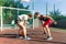 Streetball basketball game with two players, teenagers girl and boy, morning on basketball court