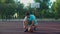 Streetball player tying shoe on outdoor court