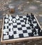 Streetchess pieces at a square. Board of a chess game. A peaceful scene of an outdoor chess match in a park.