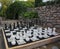 Streetchess pieces at a square. Board of a chess game. A peaceful scene of an outdoor chess match in a park.