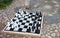 Streetchess pieces at a square. Board of a chess game. A peaceful scene of an outdoor chess match in a park.