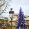 Streetlamp and Christmas tree in the background