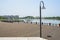 Streetlamp in fenced and planked lakeside at city on sunny summer day