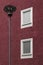 Streetlamp in front of a dark red building