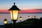 Streetlights along Dutch boulevard with beautiful sunset over the sea