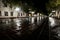 The streets glisten after the rain reflecting the light of lanterns