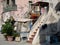 Streetview of a facade with stairs and a boat in the harbor of P