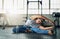 Strength is her middle name. Shot of a young attractive woman stretching in a gym.