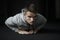 Strength and motivation. Young handsome man in sportswear doing push-up at gym