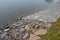 Strengthening of the banks lined with stones against water erosion on the river. The water dam on the pond is reinforced by gray b