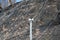 Strengthening the mountain slope with a metal mesh that prevents rockfall on the road. Abstract background of the