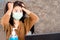 Stress Asian woman wearing protective mask angry and get depressed during covid-19 virus outbreak ,quarantine and home lockdown