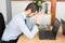 A stress businessman sitting on office desk with hand on head