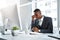 Stress is costing him his productivity. a young businessman experiencing stress while working at his desk in a modern