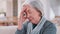 Stress, headache and senior woman in home with mental health, depression or anxiety in retirement. Migraine, pain and