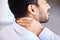 Stress, pain and sore neck closeup of businessman massaging strained muscle. Stressed corporate man suffering from a