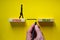 Stress or relax symbol. Wooden blocks with words `Stress, Relax`. Yellow background. Businessman hand, businesswoman icon.