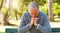 Stress, thinking and senior man in a park sitting on a bench with a contemplating face and hand gesture. Nature, outdoor