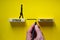 Stress or wellness symbol. Wooden blocks with words `Stress, wellness`. Yellow background. Businessman hand, businesswoman icon.