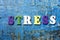 STRESS word written on abc letter at abstract grunge background.