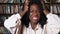 Stressed Afro-american businesswoman raises hands in despair